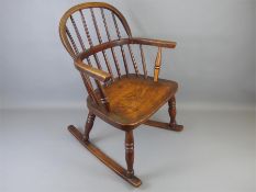 An Antique Oak Child's Windsor Rocking Chair