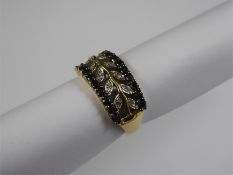 A 9ct Yellow Gold Black and White Diamond Laurel Ring