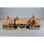 Three Ceramic Rustic Miniature Cottages.