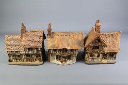 Three Ceramic Rustic Miniature Cottages.