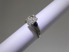 A 18ct White Gold Cushion Cut Diamond and Sapphire Ring