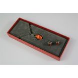 A Georg Jensen 2001 Silver and Amber Pendant and Earrings