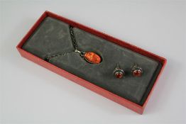 A Georg Jensen 2001 Silver and Amber Pendant and Earrings