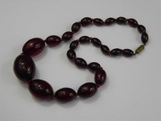 A Set of Graduated Red Amber-Style Beads