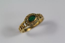 An 14-15ct Yellow Gold Diamond and Emerald Ring