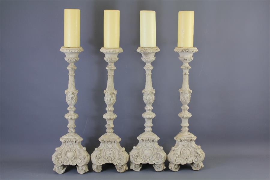 A Set of Four Composite French-style Candle Holders