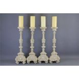 A Set of Four Composite French-style Candle Holders