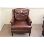 A Dark Brown Faux Leather Wing-Back Chair