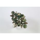 A Ladies Vintage White Gold and Green Sapphire Floral Ring