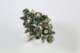 A Ladies Vintage White Gold and Green Sapphire Floral Ring