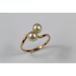 A Yellow Gold and Pearl Cross Over Ring
