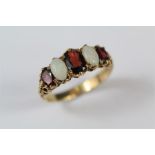 A 9ct Yellow Gold, Opal and Garnet Ring