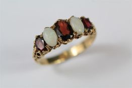 A 9ct Yellow Gold, Opal and Garnet Ring