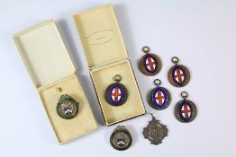 A Collection of Vintage Bronze and Enamel Sports Fob Medals