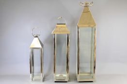 A Trio of Chrome and Glass Floor Lanterns