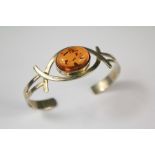 A Ladies Silver and Amber Bangle