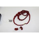 2 CHERRY RED AMBER NECKLACES + 1 PAIR OF EARRINGS