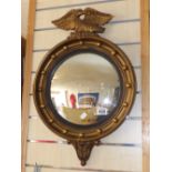 CONVEX MIRROR IN GILT FRAME, DECORATED WITH AN EAGLE