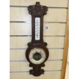 ANEROID BAROMETER IN A CARVED CASE