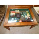 COFFEE TABLE WITH A COLLECTION OF ARSENAL MEMORABILIA UNDER GLAZED TOP