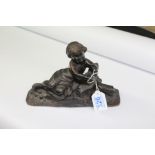 BRONZE RCLINING FIGURE OF A CHILD 16 X 23 CMS