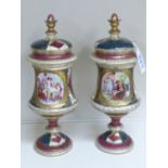 PAIR OF VIENNA LIDDED URNS DECORATED WITH CLASSICAL SCENES 27 CMS