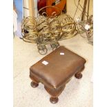 A SMALL WOOD AND LEATHER FOOTSTOOL AND GILT METAL NEWSPAPER RACK