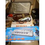 A CASED OMNICHORD BY SUZUKI AND A CASIO SONG BANK KEYBOARD SA-75