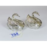 A PAIR OF GLASS AND HALLMARKED SILVER MOUNTED SWAN CONDIMENTS, APPROX 7 CM IN HEIGHT