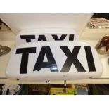 TWO MAGNETIC TAXI SIGNS FOR CAR USE. BLACK TEXT ON WHITE BACKGROUND