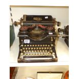A MID 20TH CENTURY ROYAL TYPEWRITER, THE SIDES WITH GLASS PANELS, 25 CM TALL