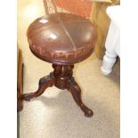A LEATHER TOPPED REVOLVING PIANO STOOL ON CARVED TRIPOD LEGS, 48 CM TALL