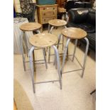 A SET OF FOUR METAL AND WOOD SCHOOL LAB STOOLS, 70 CM TALL