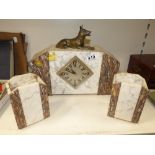 A FRENCH ART DECO MARBLE CLOCK, THE WITH A SPELTER DOG, WITH MARBLE SIDE SUPPORTS. CLOCK IS 35 CM