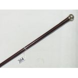 A SILVER TOPPED WALKING STICK - WITH BRIGHTON CONNECTION. 77 CM LONG