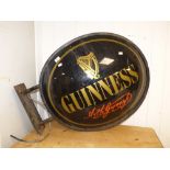A LARGE METAL AND PLASTIC WALL MOUNTED GUINNESS ADVERTISING SIGN, DOUBLE SIDED. ONE SIDE IS A/F.