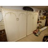 TWO CREAM AND GILT DECORATED WARDROBES WITH DRESSING TABLE AND CABINET