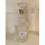 A CUT GLASS DECANTER WITH SILVER COLLAR