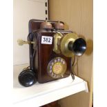 A VINTAGE MAHOGANY AND BRASS TELEPHONE