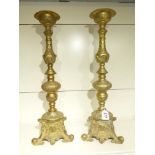 A LARGE PAIR OF GILT BRASS CANDLE STICKS WITH ENGRAVED DECORATION ALL OVER - 60 CM TALL