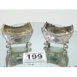 A PAIR OF SILVER FANCY-WORK SALTS WITH GLASS LINERS, LONDON 1884/5, MAKER ORLANDO JACKSON. WEIGHT