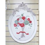 AN OVAL PAINTED FLORAL WALL PLAQUE