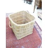 A WICKER LAUNDRY BASKET