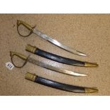 A PAIR OF CURVED SHORT SWORDS IN LEATHER SCABBARDS, MARKED TO BLADE "MADE IN INDIA" 53 CM LONG