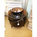 A LARGE BLACK PAINTED CAULDRON, RAISED ON TRIPOD SUPPORT, TOGETHER WITH A SMALLER EXAMPLE. LARGEST