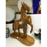 A CARVED WOODEN FIGURE OF A HORSE