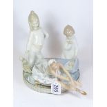 A LLADRO CERAMIC FIGURE OF AN ANGEL ABOVE A SLEEPING CHILD, TOGETHER WITH 2 SIMILAR STYLE FIGURES