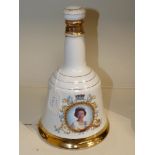 A BELLS WHISKY DECANTER COMMEMORATING THE QUEENS 60TH BIRTHDAY IN 1986