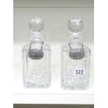 A PAIR OF CUT GLASS DECANTERS WITH A WHISKY AND BRANDY LABEL - 25 CM
