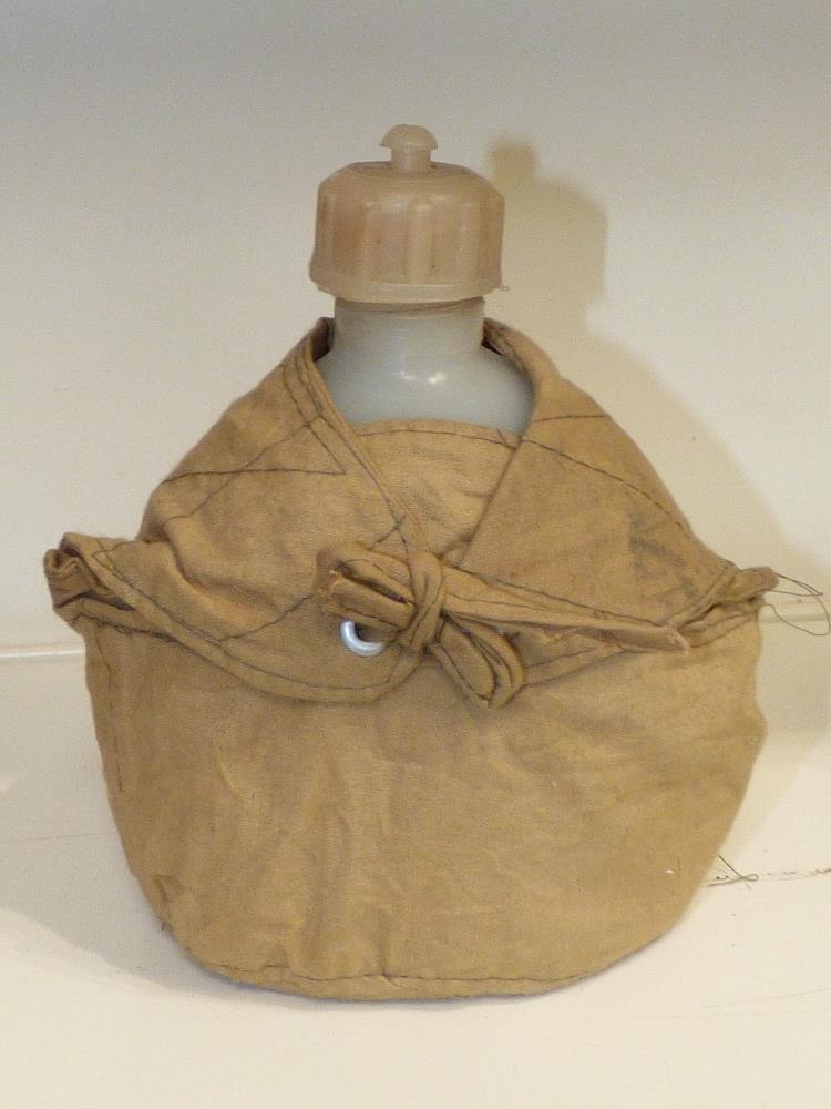 VIETNAM WAR ERA N.V.A-VC PLASTIC WATER BOTTLE IN DRY SEASON POUCH - Image 2 of 2